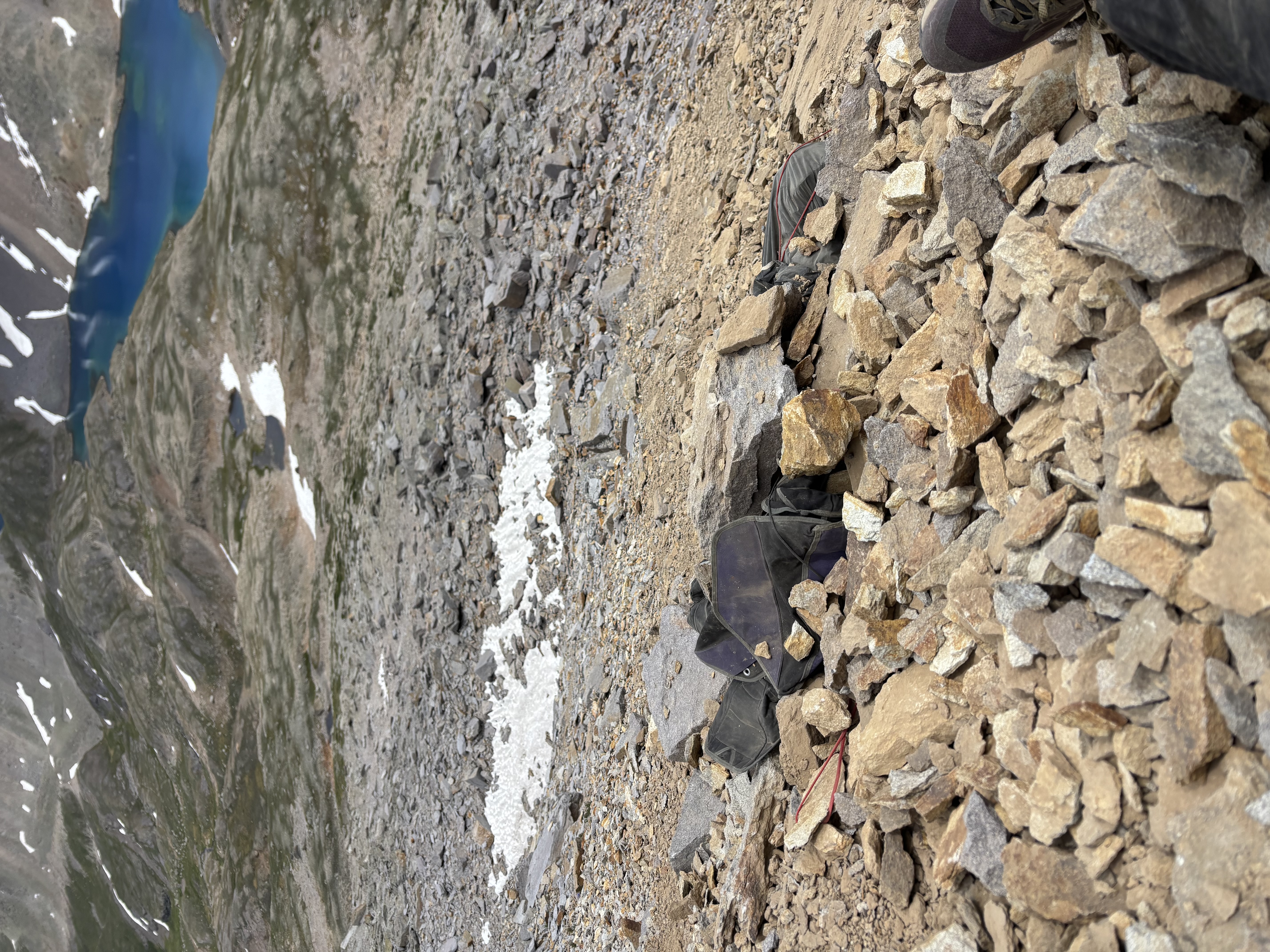 Gear partially buried in a rockslide at the accident site